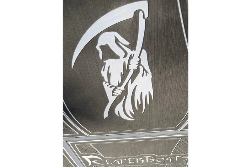 Slide: The Image of Man operating 2025 Reaper Boats 550 with Yamaha outboard motor on a calm river. - 2