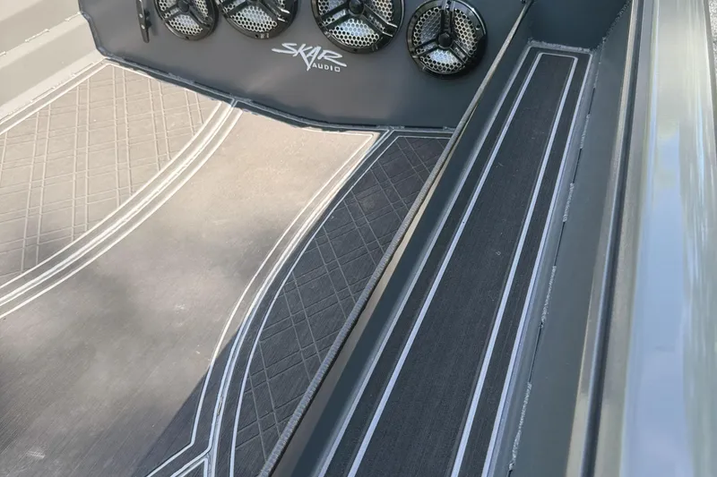 Slide: The Image of 2025 Reaper Boats 550 deck with intricate design and logo. - 5