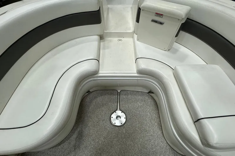 Slide: The Image of Interior seating of a 2006 Sea Ray 290 Select EX boat, featuring white and black upholstery. - 13