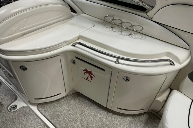 Slide: The Image of 2006 Sea Ray 290 Select EX boat interior with storage and cup holders. - 14