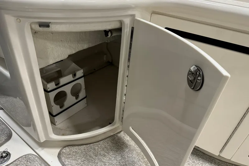 Slide: The Image of Open storage compartment on 2006 Sea Ray 290 Select EX boat interior. - 16