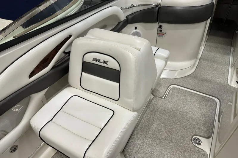Slide: The Image of 2006 Sea Ray 290 Select EX interior with white leather seating and carpeted flooring. - 19