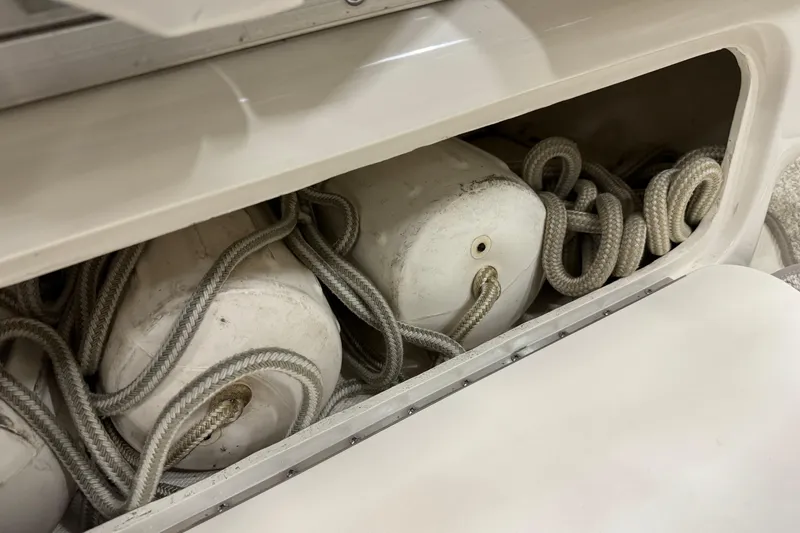 Slide: The Image of Storage compartment with ropes and fenders on a 2006 Sea Ray 290 Select EX boat. - 21
