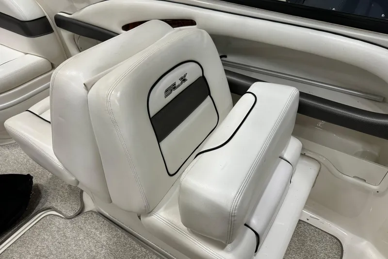 Slide: The Image of White leather seating in a 2006 Sea Ray 290 Select EX boat interior. - 23