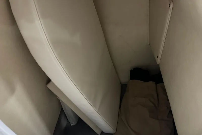 Slide: The Image of Interior cabin of 2006 Sea Ray 290 Select EX boat with beige cushions. - 32