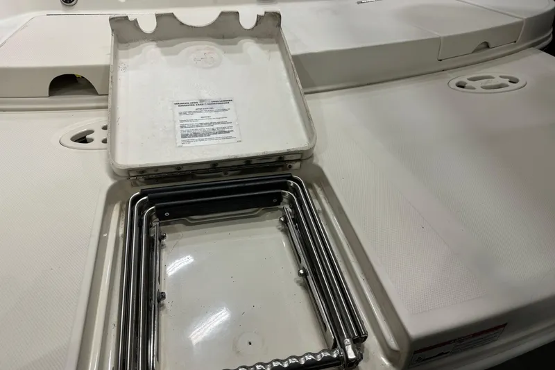 Slide: The Image of 2006 Sea Ray 290 Select EX boat ladder compartment, open with visible metal ladder. - 9