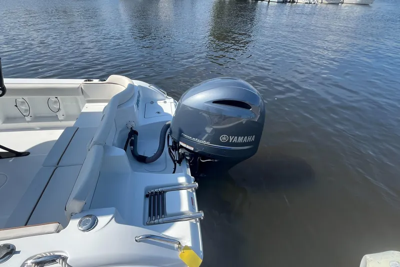 Slide: The Image of 2022 Sea Hunt Ultra 219 boat with Yamaha outboard motor on calm water. - 10