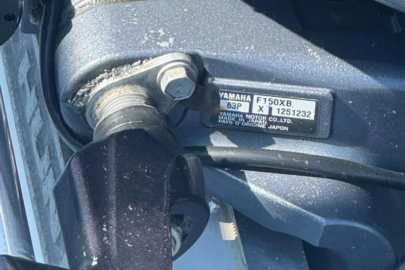 Slide: The Image of Close-up of a Yamaha F150XB engine part on a 2022 Sea Hunt Ultra 219 boat. - 11