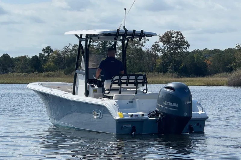 Slide: The Image of 2022 Sea Hunt Ultra 219 boat with Yamaha engine on calm water. - 20