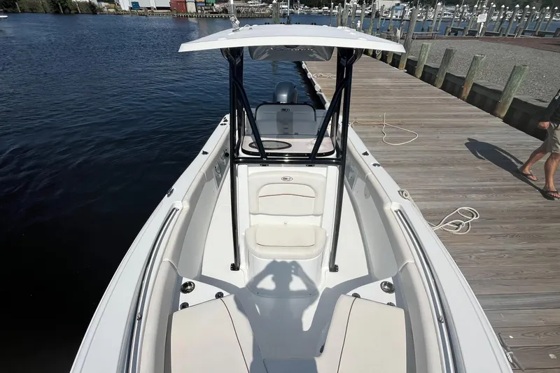 Slide: The Image of 2022 Sea Hunt Ultra 219 boat docked, featuring spacious seating and sleek design. - 4