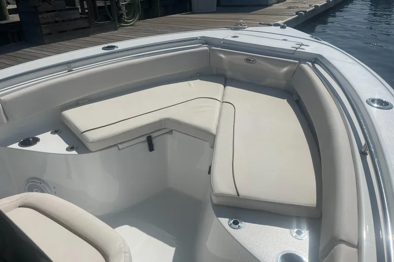 Slide: The Image of 2022 Sea Hunt Ultra 219 boat interior with cushioned seating and cup holders. - 5