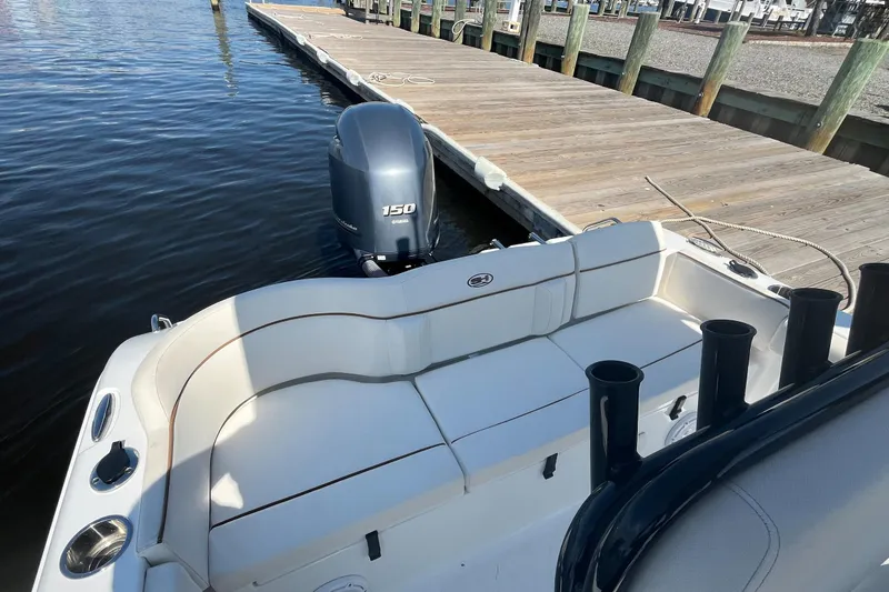 Slide: The Image of 2022 Sea Hunt Ultra 219 boat docked, featuring a 150 horsepower engine. - 6