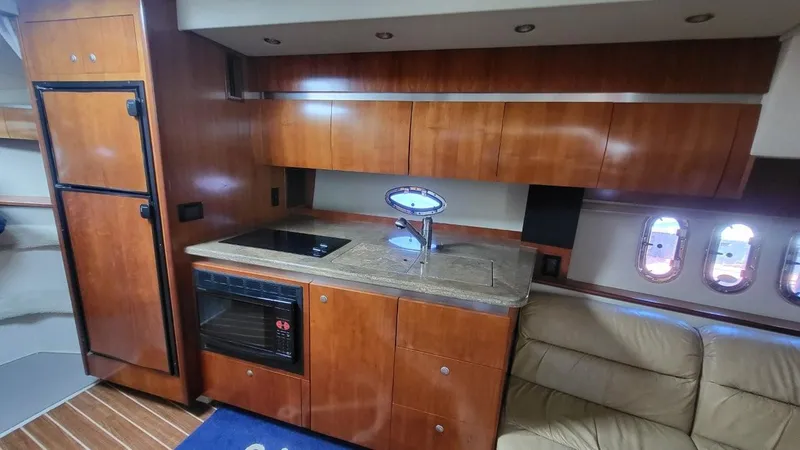 Slide: The Image of Luxurious 2008 Cruisers 420 Express yacht interior with modern kitchen and elegant wood cabinetry. - 11