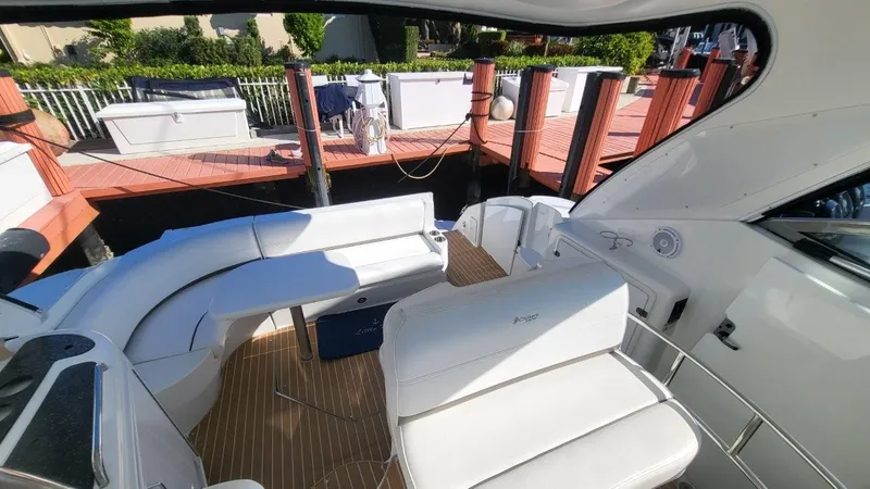 Slide: The Image of 2008 Cruisers 420 Express yacht interior with white seating and wooden deck. - 4