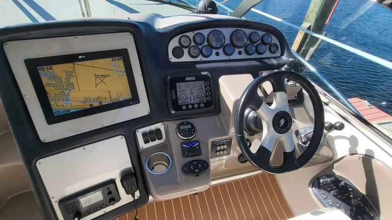Slide: The Image of 2008 Cruisers 420 Express helm with navigation system and steering wheel, dockside view. - 8