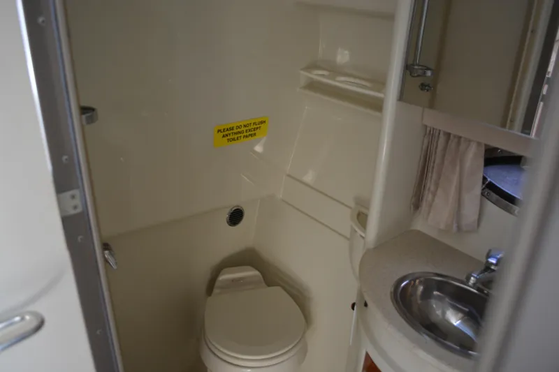 Slide: The Image of 2006 Formula 34 Performance Cruiser bathroom with toilet, sink, and caution sign. - 25