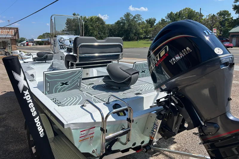 Slide: The Image of 2026 Xpress H20B Bay boat with Yamaha engine, parked outdoors on a sunny day. - 4