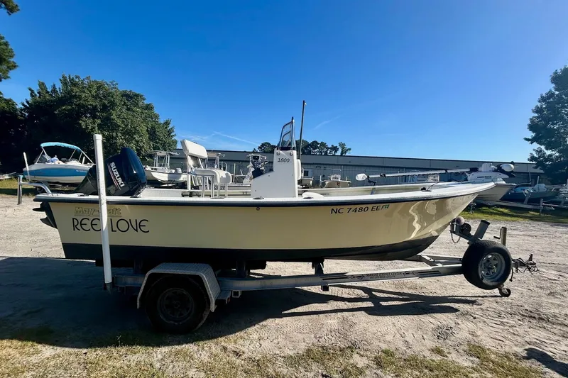 Slide: The Image of 2017 May-Craft 1800CC boat on trailer, labeled "Reel Love," with Suzuki outboard motor. - 2
