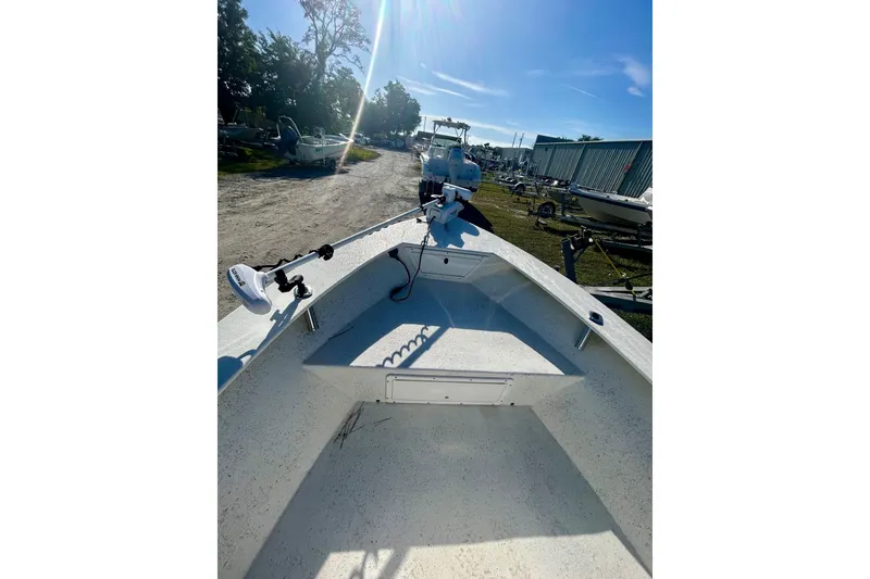 Slide: The Image of 2017 May-Craft 1800CC boat with trolling motor, parked outdoors under clear blue sky. - 4