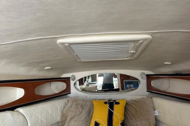 Slide: The Image of Interior cabin of 2004 Sea Ray 260 Sundancer with cozy seating and decorative pillows. - 11