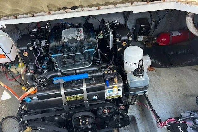 Slide: The Image of Engine compartment of a 2004 Sea Ray 260 Sundancer boat, featuring detailed components and wiring. - 12