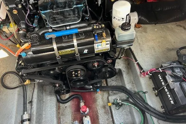 Slide: The Image of Engine compartment of a 2004 Sea Ray 260 Sundancer boat, showcasing mechanical components. - 13