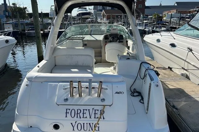 Slide: The Image of 2004 Sea Ray 260 Sundancer boat named "Forever Young" docked at a marina. - 4