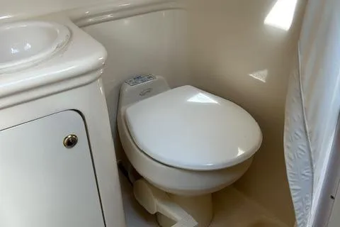 Slide: The Image of 2004 Sea Ray 260 Sundancer bathroom with toilet and sink. - 7
