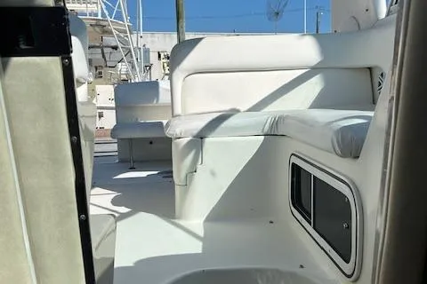 Slide: The Image of 2004 Sea Ray 260 Sundancer interior with white seating and storage compartments. - 8