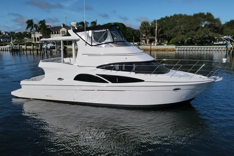 Slide: The Image of 2005 Carver 41 Cockpit Motor Yacht on calm water, showcasing sleek design and luxury features. - 0