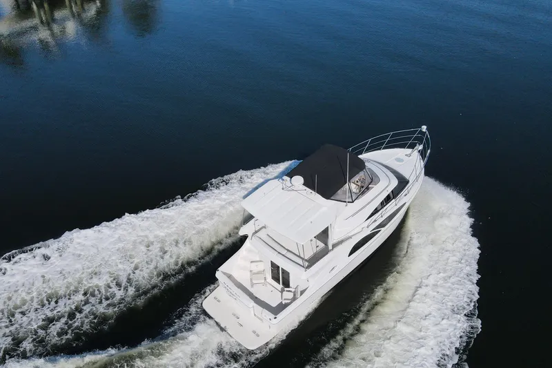 Slide: The Image of 2005 Carver 41 Cockpit Motor Yacht cruising on calm waters, aerial view. - 10