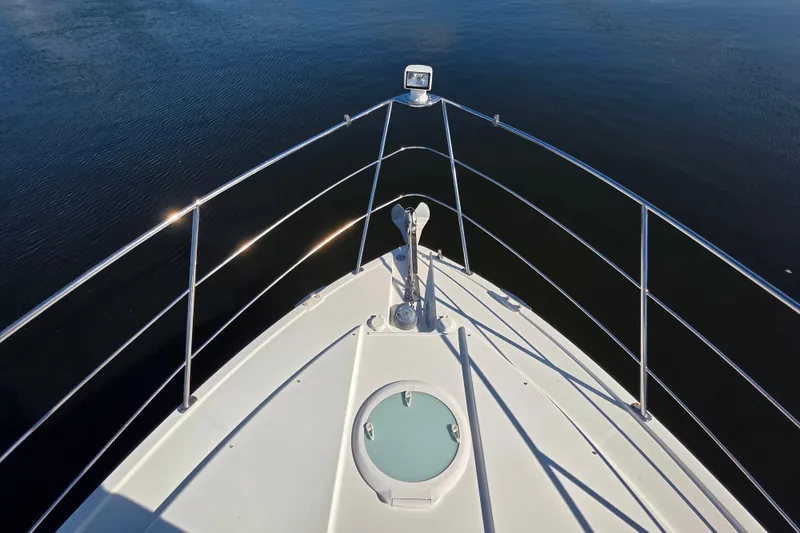 Slide: The Image of Bow view of 2005 Carver 41 Cockpit Motor Yacht on calm water. - 12