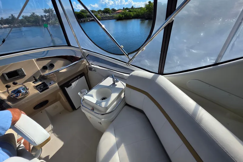 Slide: The Image of 2005 Carver 41 Cockpit Motor Yacht interior with helm, seating, and water view. - 15