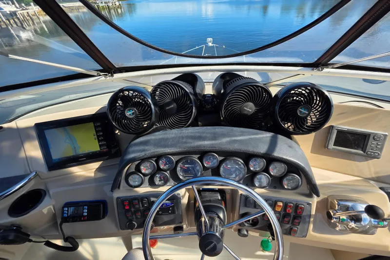 Slide: The Image of 2005 Carver 41 Cockpit Motor Yacht helm with navigation screens and controls. - 16