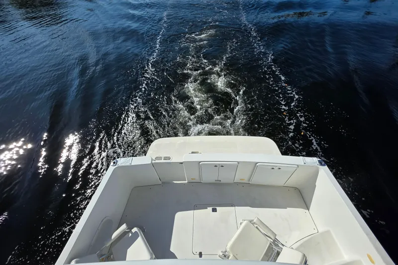 Slide: The Image of 2005 Carver 41 Cockpit Motor Yacht cruising on water, view from stern. - 17