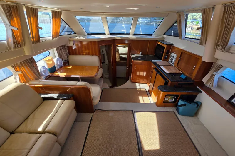 Slide: The Image of Luxurious interior of 2005 Carver 41 Cockpit Motor Yacht with elegant furnishings and ample natural light. - 21