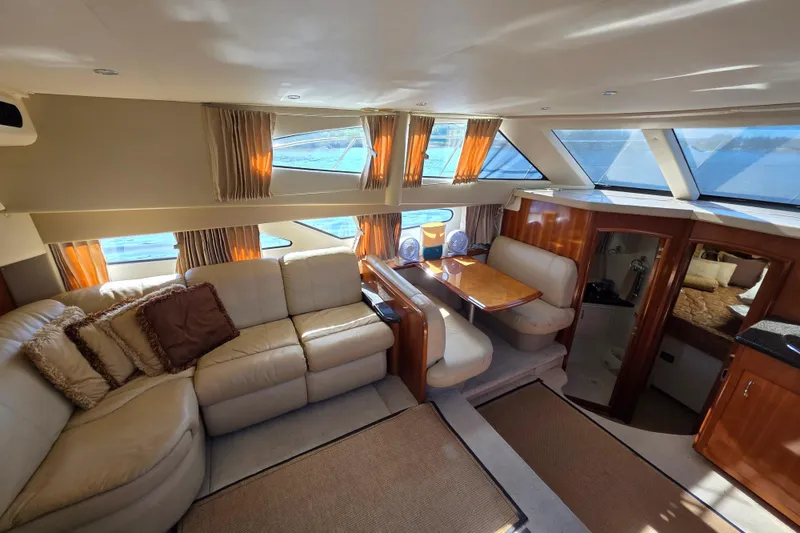 Slide: The Image of Luxurious interior of 2005 Carver 41 Cockpit Motor Yacht with plush seating and dining area. - 23
