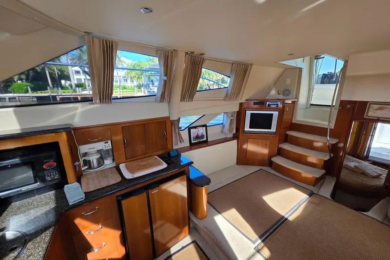 Slide: The Image of Interior of 2005 Carver 41 Cockpit Motor Yacht with kitchen and living area. - 24