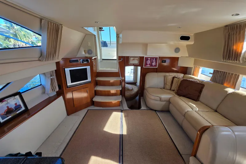 Slide: The Image of Luxurious interior of 2005 Carver 41 Cockpit Motor Yacht with plush seating and entertainment area. - 25