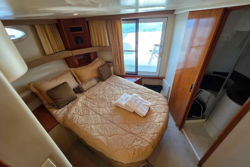 Slide: The Image of Luxurious bedroom in 2005 Carver 41 Cockpit Motor Yacht with cozy bedding and ocean view. - 26