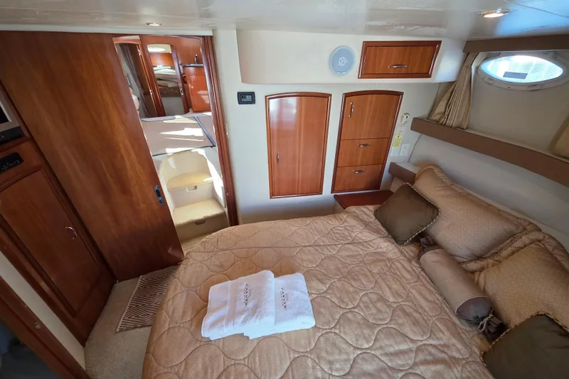 Slide: The Image of Luxurious interior of 2005 Carver 41 Cockpit Motor Yacht with cozy bedroom and elegant wood finishes. - 28
