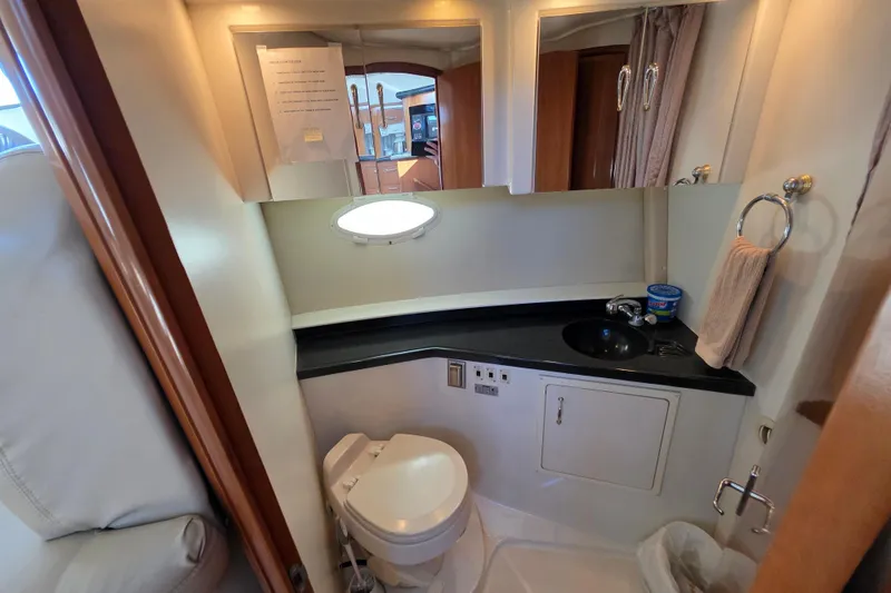 Slide: The Image of 2005 Carver 41 Cockpit Motor Yacht bathroom with sink, toilet, and mirror. - 29