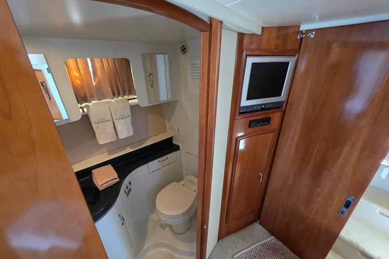 Slide: The Image of Luxurious bathroom in 2005 Carver 41 Cockpit Motor Yacht with wood accents and modern amenities. - 31