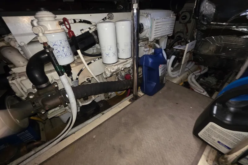 Slide: The Image of Engine room of 2005 Carver 41 Cockpit Motor Yacht with filters and oil containers. - 36