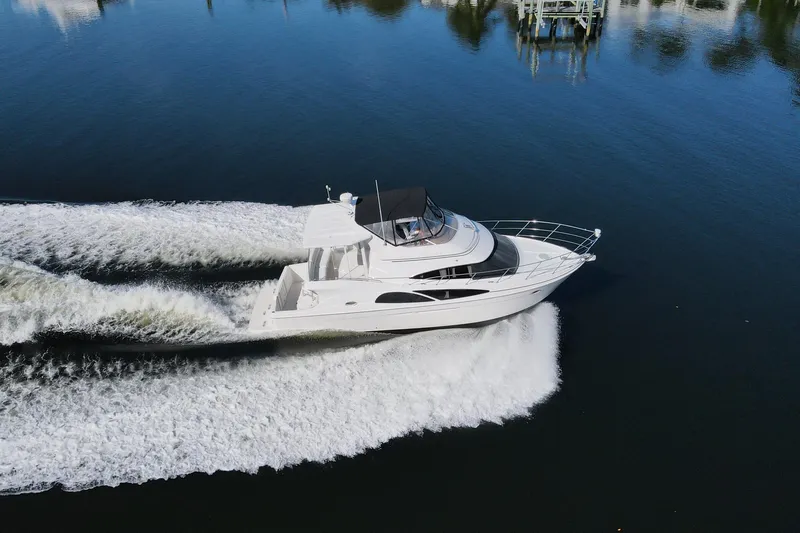 Slide: The Image of 2005 Carver 41 Cockpit Motor Yacht cruising on calm water, aerial view. - 9