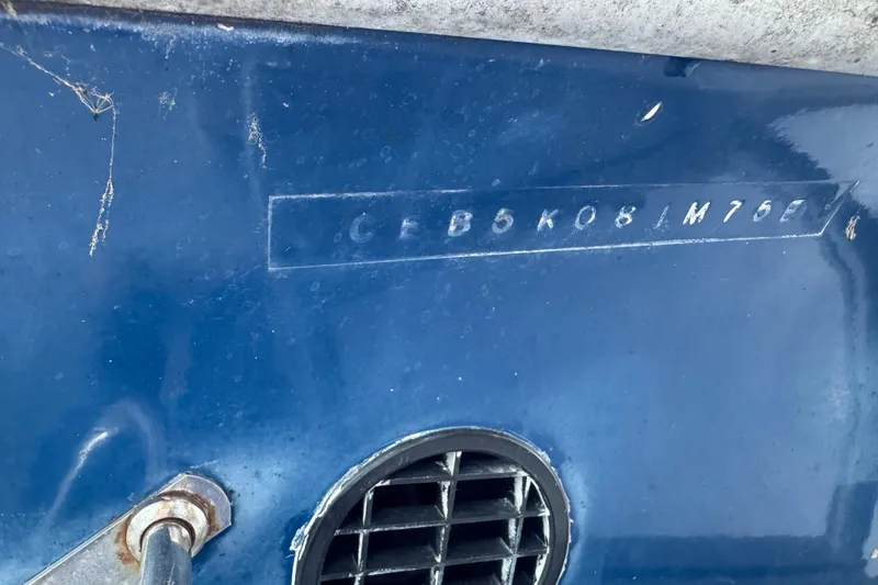 Slide: The Image of 1975 Century Raven boat hull with visible serial number on blue surface. - 11