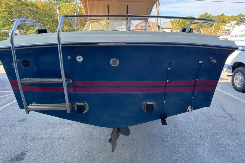 Slide: The Image of 1975 Century Raven boat stern with ladder and red stripe detailing. - 2