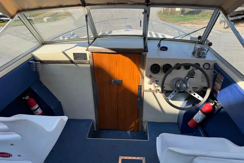 Slide: The Image of Interior of a 1975 Century Raven boat with steering wheel and dashboard. - 4