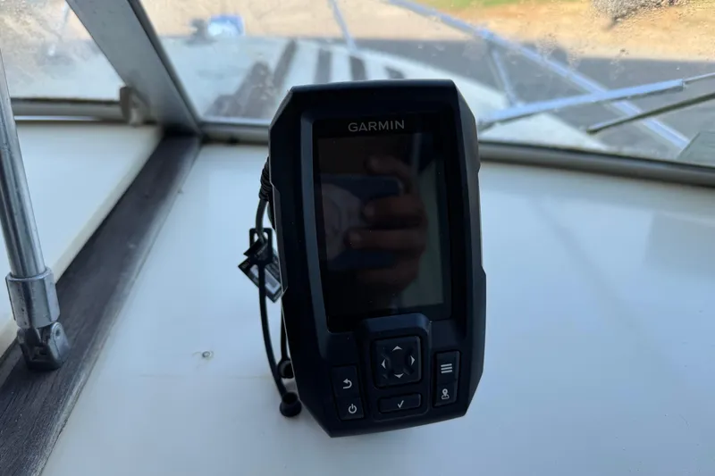 Slide: The Image of Garmin device on 1975 Century Raven boat dashboard, with window view. - 7