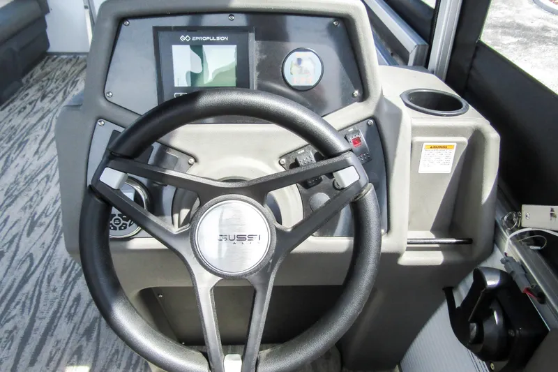 Slide: The Image of Steering wheel and dashboard of 2025 Armada v17 boat with control panel. - 18